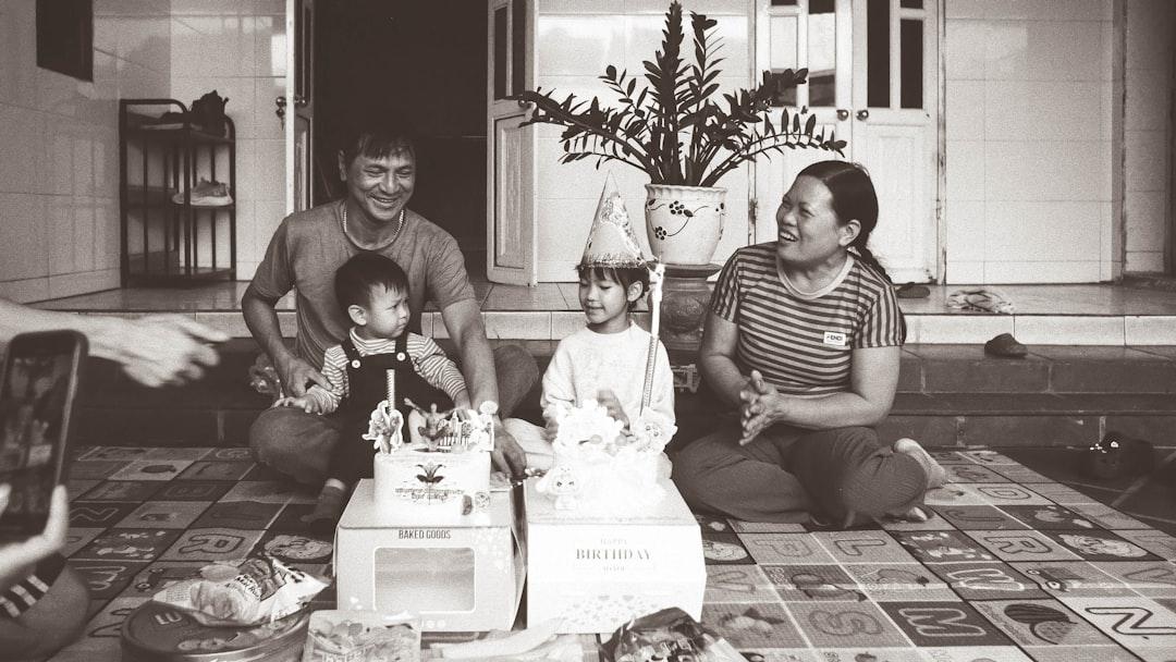 Una famiglia si è riunita intorno a una torta di compleanno, sorridendo.