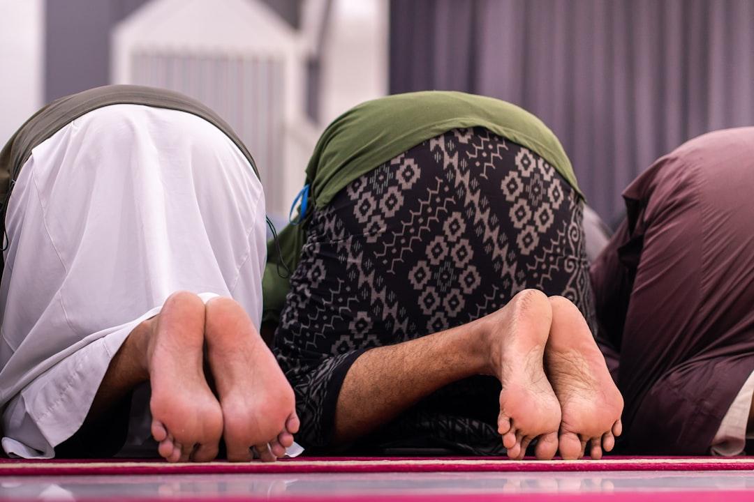 A person laughing while stretching in a bright, colorful yoga studio