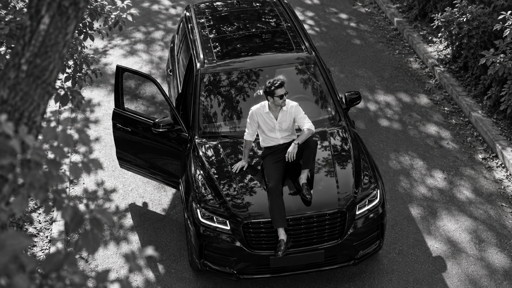 a confident adult portrait photographed from above while sitting safely on the hood of an unbranded parked SUV, with believable body-to-car contact