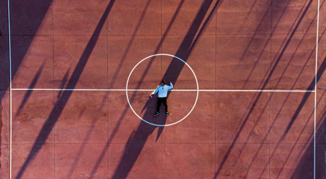 A dramatic shot of a baseball field from the perspective of a player walking out of the dugout, symbolizing a journey and a challenge ahead.